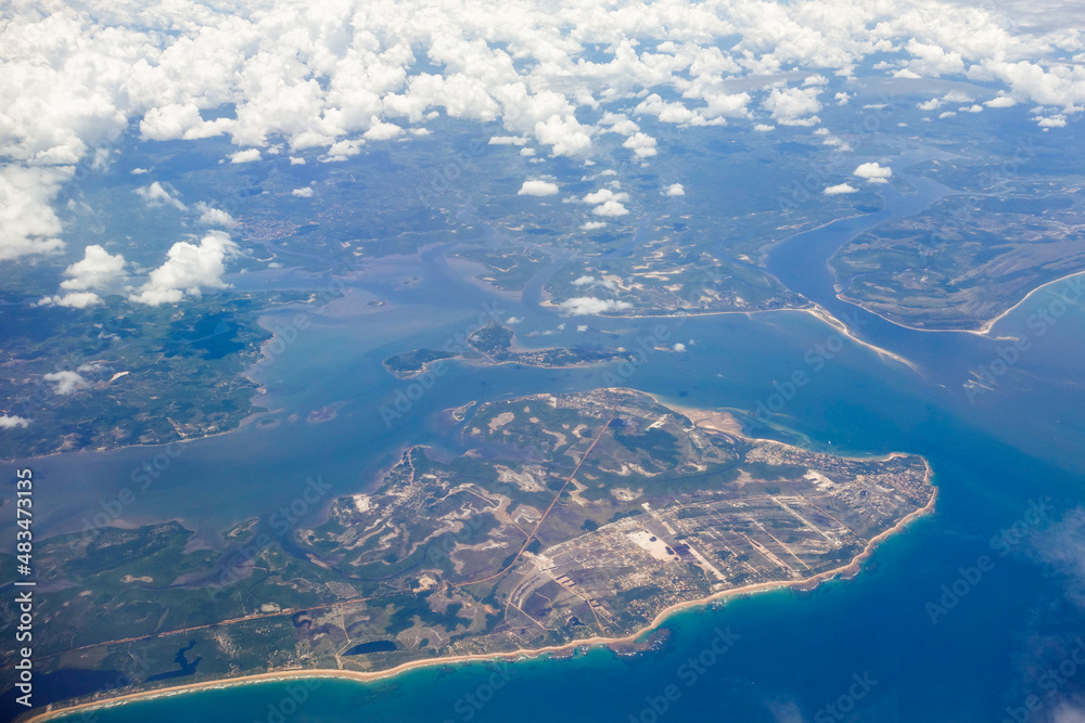 aerial view over tropical peninsula in brazilian coast, under clouds