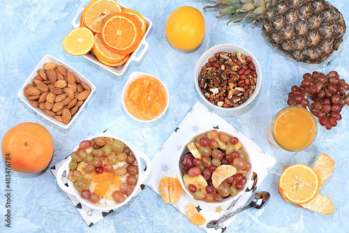 Detox diet and weight loss concept, healthy breakfast with ingredients, Fruit drink and summer tropical fruits, juices, smoothies on blue table, top view, healthy and natural food, source of vitamin C