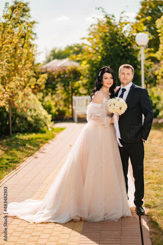 bride and groom in the park. wedding walk on the day of the celebration. bride and groom in the park. wedding walk on the day of the celebration.