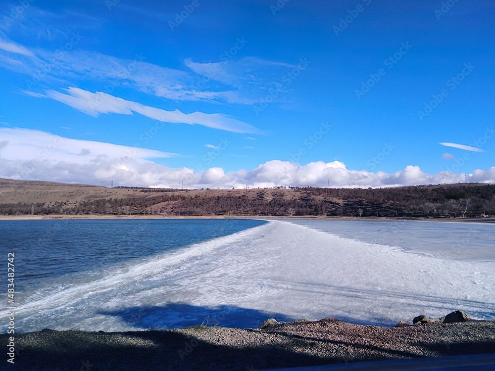 half frozen lake, view of half frozen lake from side, background image with half frozen blue lake half frozen lake, view of half frozen lake from side, background image with half frozen blue lake