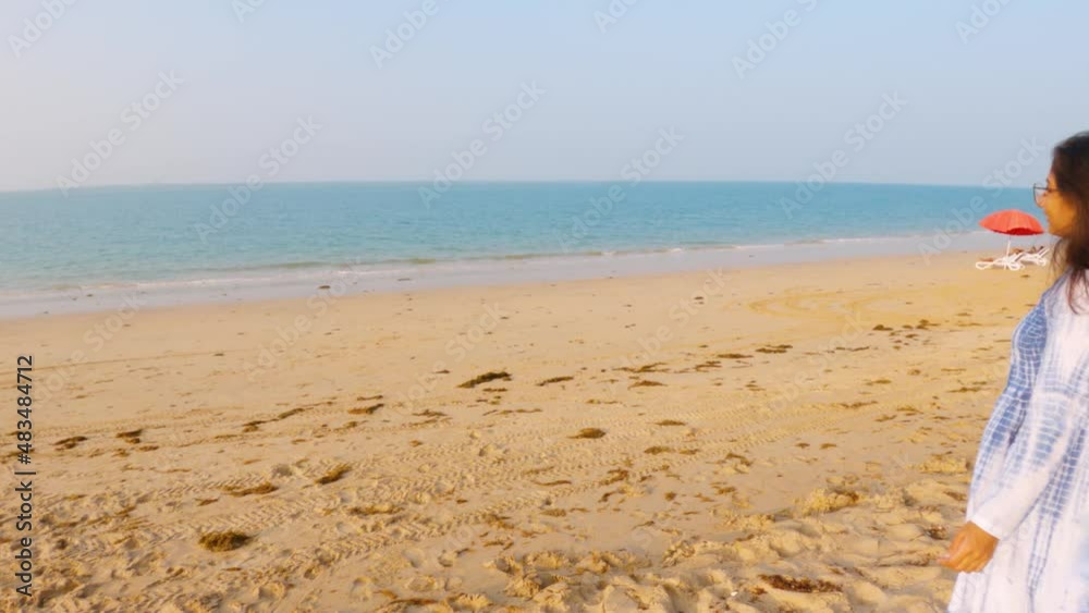 Beautiful Indian girl enjoying view of blue ocean. Tropical beach background during summer vacation holidays Beautiful Indian girl enjoying view of blue ocean. Tropical beach background during summer vacation holidays