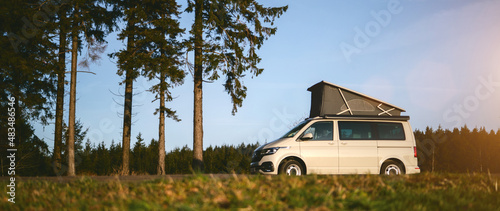 Fotografie, Tablou Modern Camping Van parking at the forest in beautiful, authentic nature