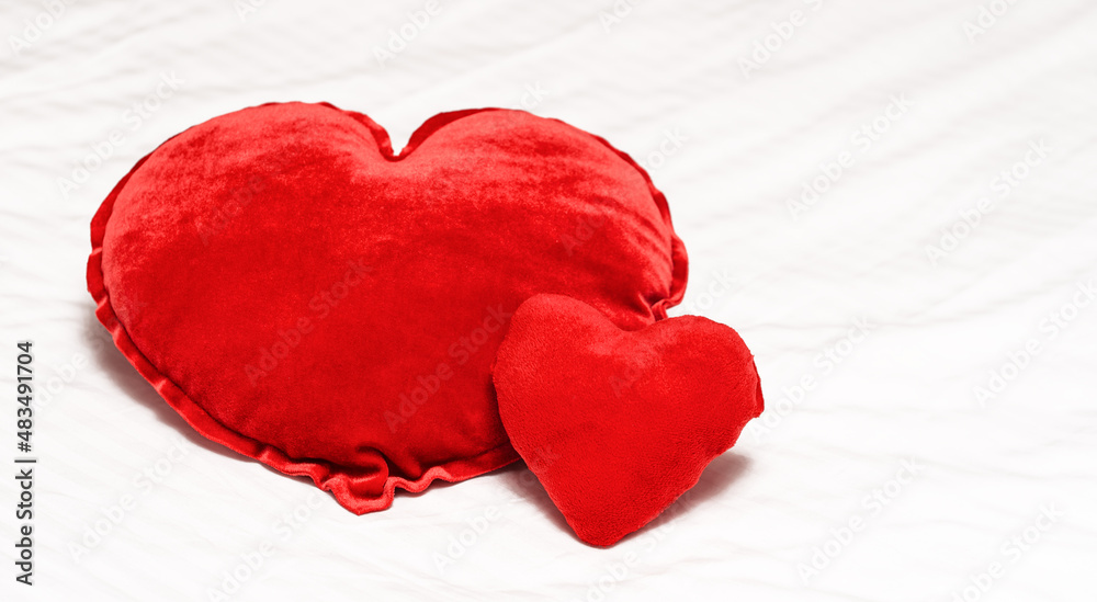 Two Red hearts shaped pillow on bed in bedroom. Valentine's day couple concept.