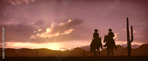 Silhouette of a couple of Cowboys (him and her) at sunset © ginettigino