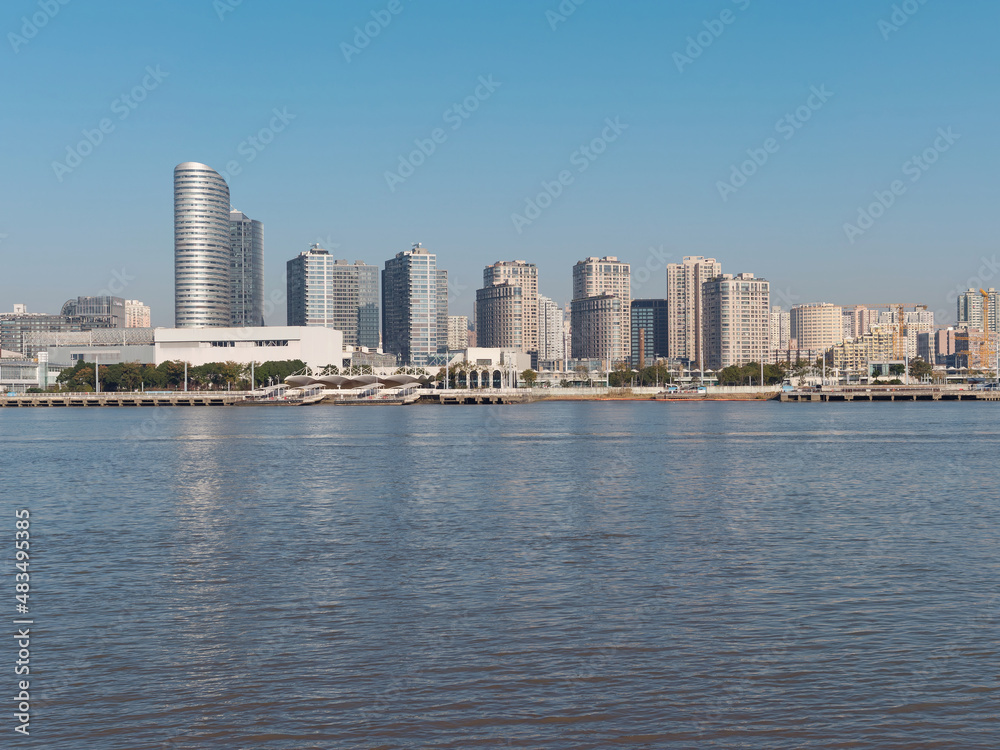 Shanghai city skyline along Huangpu river in sunny day.