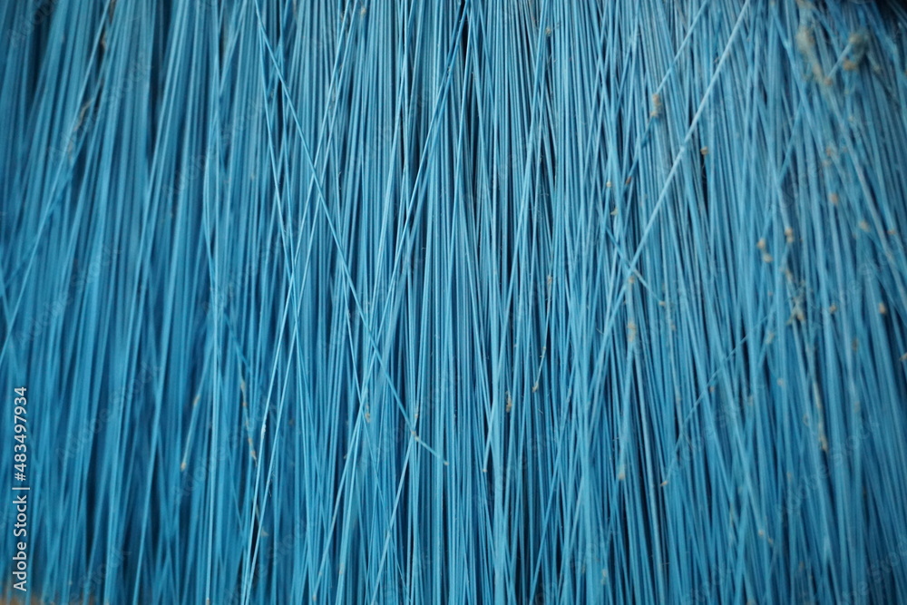 Obraz premium is a macro image of a broom that is blue in color, you can see parts of the broom and the dust attached to it, the background