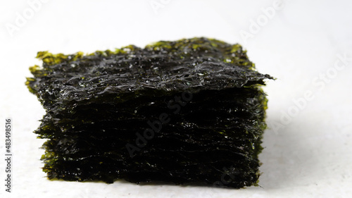 A close-up image of laver against a white background. Concept about healthy seaweed food ingredients.
 photo