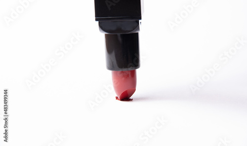 Red lipstick draw on a white background. The concept of the beauty industry, upside down