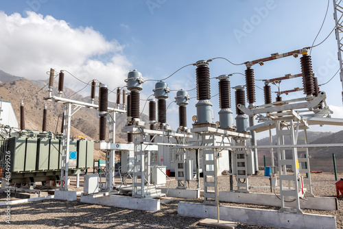 View of the electrical substation (electrical switchyard) for industrial mining plant on the mountain. A substation is a part of an electrical generation, transmission, and distribution system.