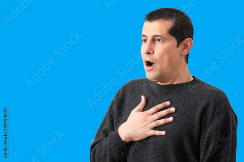 Man suffering respiratory problems with blue background