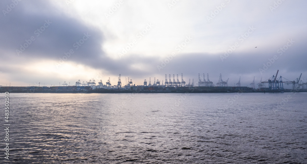 Naklejka premium The cranes at the Port of Hamburg on a misty day - travel photography
