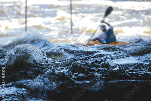 Kayak slalom canoe race in white water rapid river, process of kayaking competition with colorful canoe kayak boat paddling, process of canoeing with big water splash photo