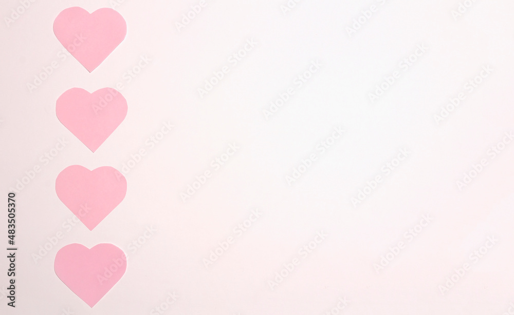 Pink paper hearts on a white background