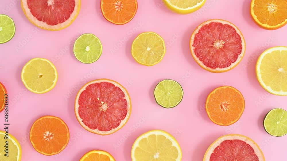 Blinking pattern made of citrus half sliced fruits on pastel pink theme. Stop motion flat lay Blinking pattern made of citrus half sliced fruits on pastel pink theme. Stop motion flat lay