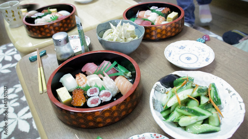 Sushi and sashimi with soya sauce on wooden table in Tokyo