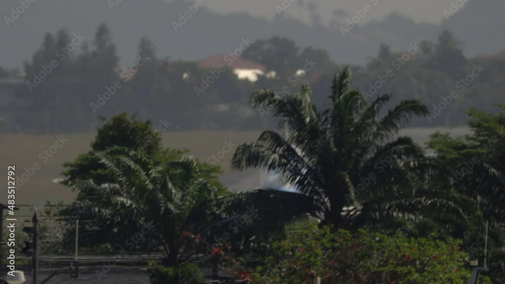 Aircraft telephoto scene of airliner landing on USM airport- from aft perspective - Koh Samui island - Thailand