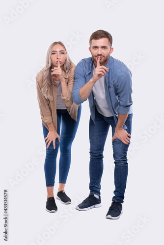 Couple Silence Sign. Couple Shush. Couple Standing Isolated Leaning Forward Sign