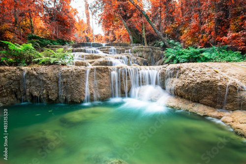 Amazing in nature, beautiful waterfall at colorful autumn forest in fall season.	
