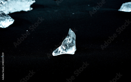 Shards of Diamond-Like Ice Line Black Sand Diamond Beach in Iceland photo