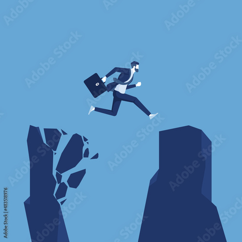 Businessman with a briefcase jumping from a crumbing mountain rock to another safer rock, reaching safety from an risky unsafe business environment concept