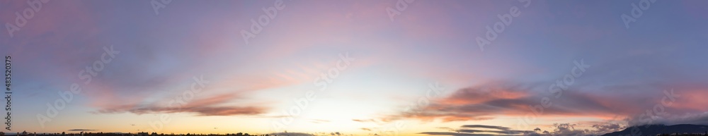 Obraz premium Panoramic View of Cloudscape during a colorful sunset or sunrise. Taken on the West Coast of British Columbia, Canada. Nature Background Panorama