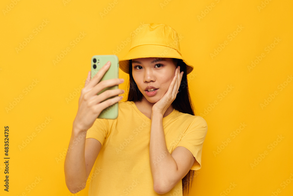 pretty brunette holding a phone posing lifestyle technology isolated background unaltered pretty brunette holding a phone posing lifestyle technology isolated background unaltered