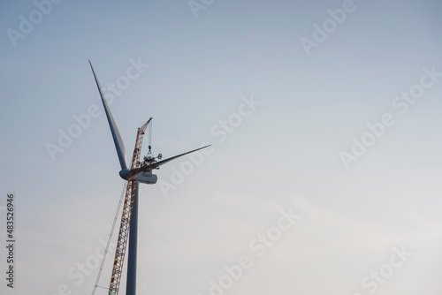 Work on windmill with cloud and minimal background, building a windmill
