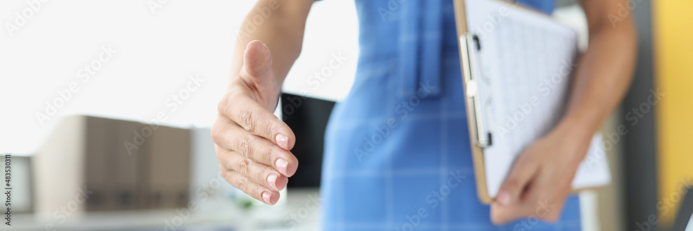 Businesswoman stretches out hand for handshake closeup