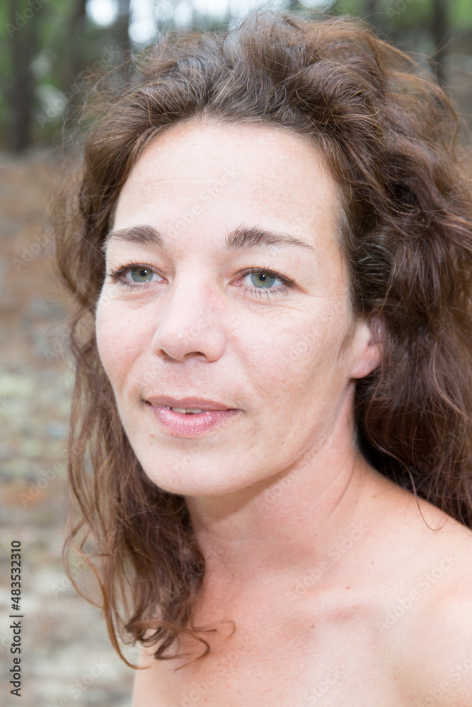 middle aged portrait woman brunette curly on sunny day outside middle aged portrait woman brunette curly on sunny day outside