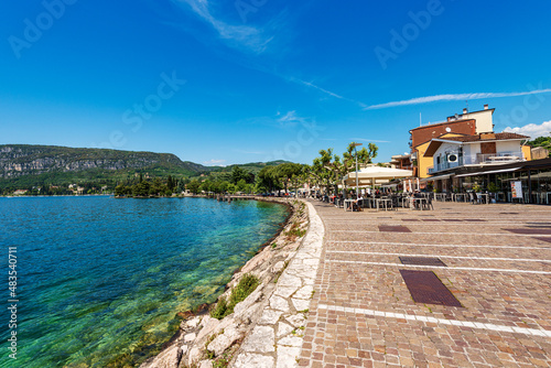 Fototapeta Naklejka Na Ścianę i Meble -  Downtown of Garda, village and tourist resort on the coast of Lake Garda (Lago di Garda). Promenade with bars and restaurants along the lakeshore. Verona province, Veneto, Italy, Europe.