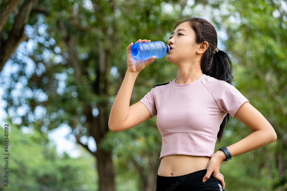 Asian woman runners she is drinking water Asian woman runners she is drinking water