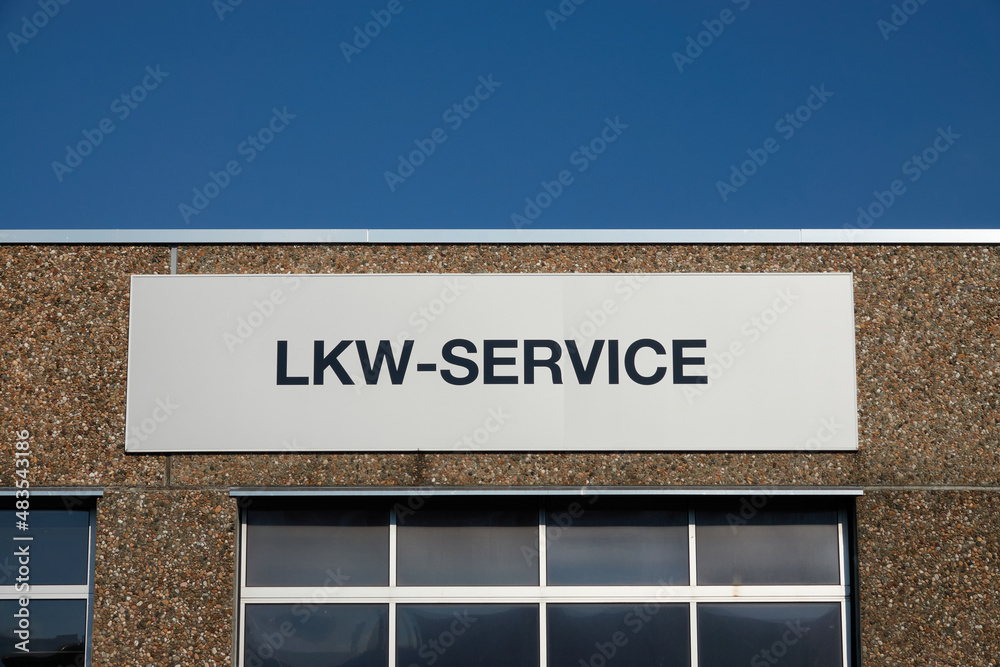 Truck (LKW) Servive. Gate to the workshop in front of blue sky.