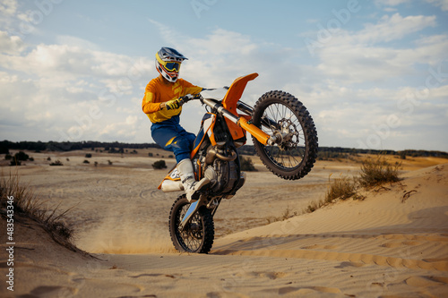 Fototapeta Naklejka Na Ścianę i Meble -  Skilled moto rider making stunt on motorbike