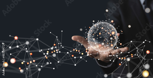 Businessman hand holding global network, futuristic technology background, Global business, internet network connection, IoT Internet of Things, business intelligence concept