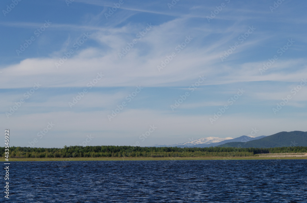 Beautiful view of the clouds and mountains from the bank of the Barguzin River.