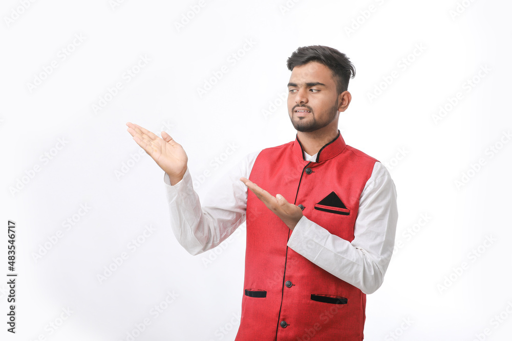Young indian man in traditional wear and giving expression on white background. Young indian man in traditional wear and giving expression on white background.