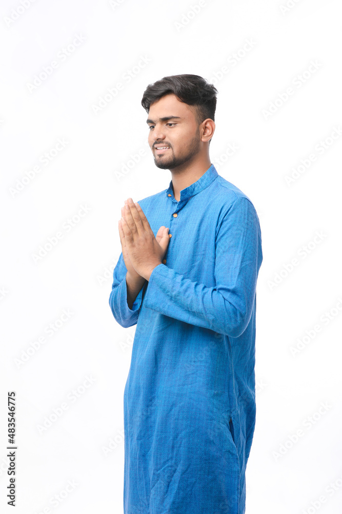 Young indian man in traditional wear and giving namaste or welcome gesture. Young indian man in traditional wear and giving namaste or welcome gesture.