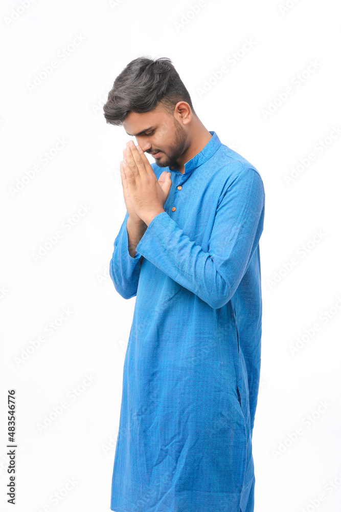Young indian man in traditional wear and giving namaste or welcome gesture. Young indian man in traditional wear and giving namaste or welcome gesture.