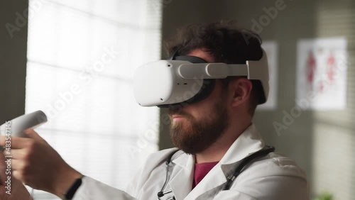 Portrait of professional Caucasian male doctor in VR glasses sitting in hospital cabinet