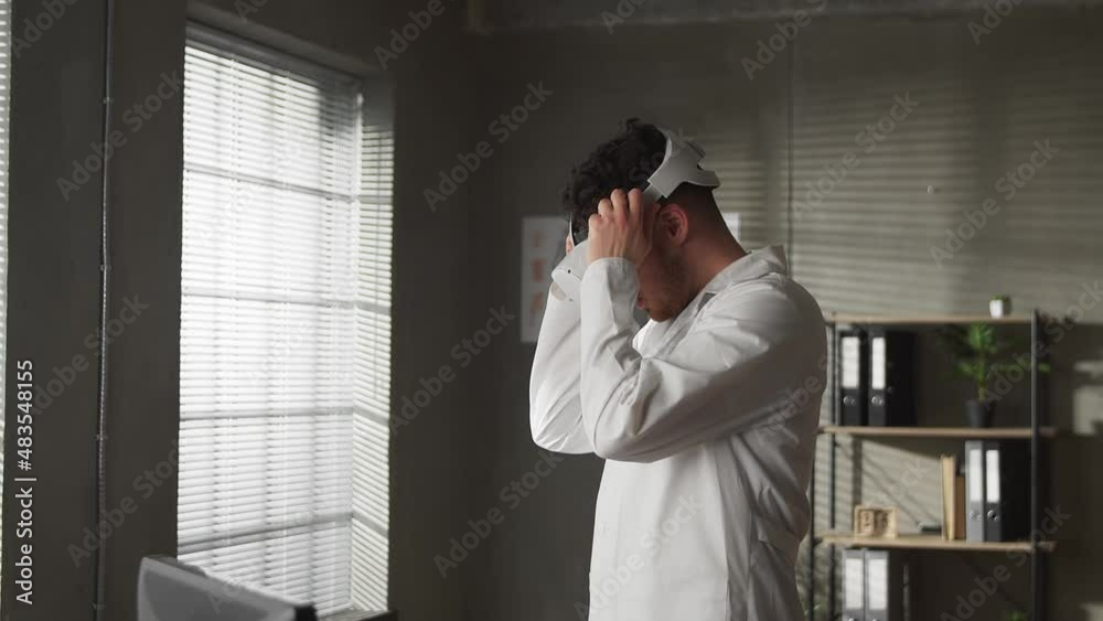 Portrait of a professional caucasian male doctor takes off his virtual reality glasses after work Portrait of a professional caucasian male doctor takes off his virtual reality glasses after work