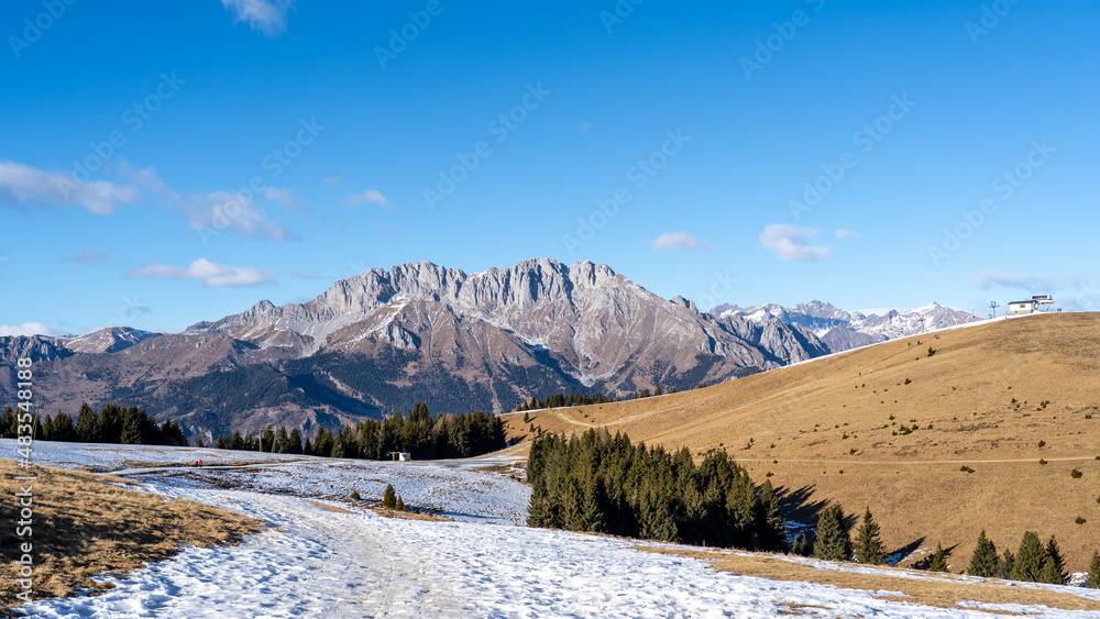 Wonderful landscape to the Presolana mountain range in winter dry season. View from Monte Pora. Orobie alps, Bergamo, Lombardy, Italy