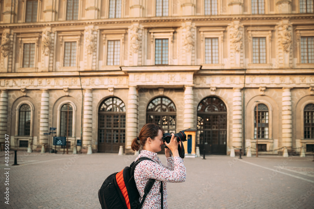 Stockholm, Sweden. Young Adult Caucasian Woman Lady Tourist Traveler Photographer Taking Pictures Photos Near Stockholm Palace. Royal Palace In Old Town Gamla Stan. Famous Popular Place. UNESCO