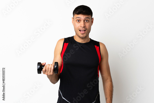 Young sport woman making weightlifting with surprise and shocked facial expression