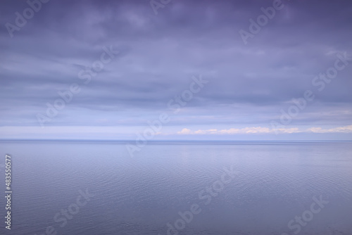 sky above water / texture background, horizon sky with clouds on the lake