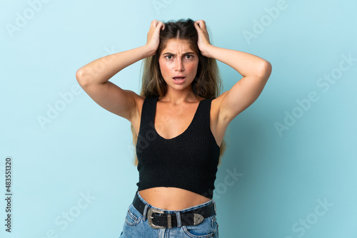Young caucasian woman isolated on blue background doing nervous gesture
