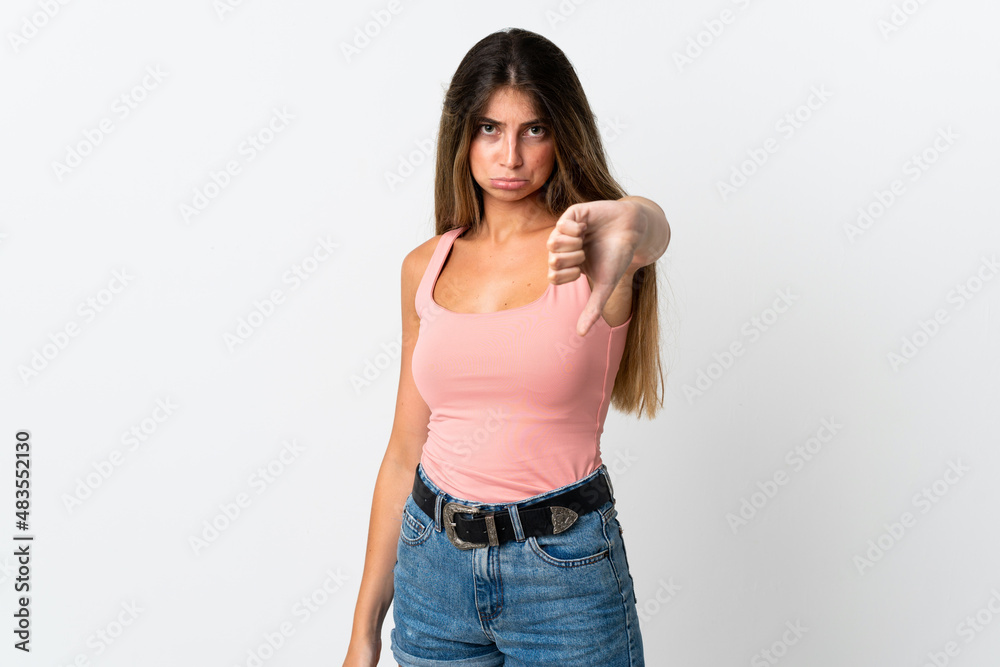 Young caucasian woman isolated on white background showing thumb down with negative expression Young caucasian woman isolated on white background showing thumb down with negative expression