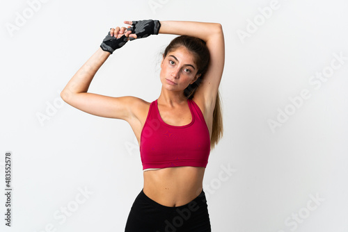Young caucasian woman isolated on white background stretching