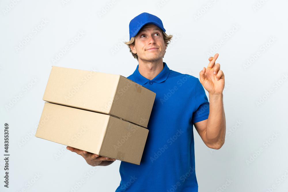 Delivery man over isolated white background with fingers crossing and wishing the best Delivery man over isolated white background with fingers crossing and wishing the best