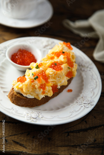 Scrambled eggs toast with cream cheese and caviar