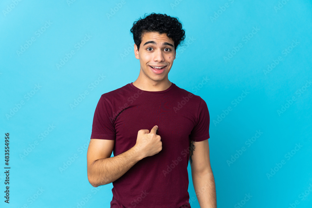 Young Venezuelan man isolated on blue background with surprise facial expression Young Venezuelan man isolated on blue background with surprise facial expression